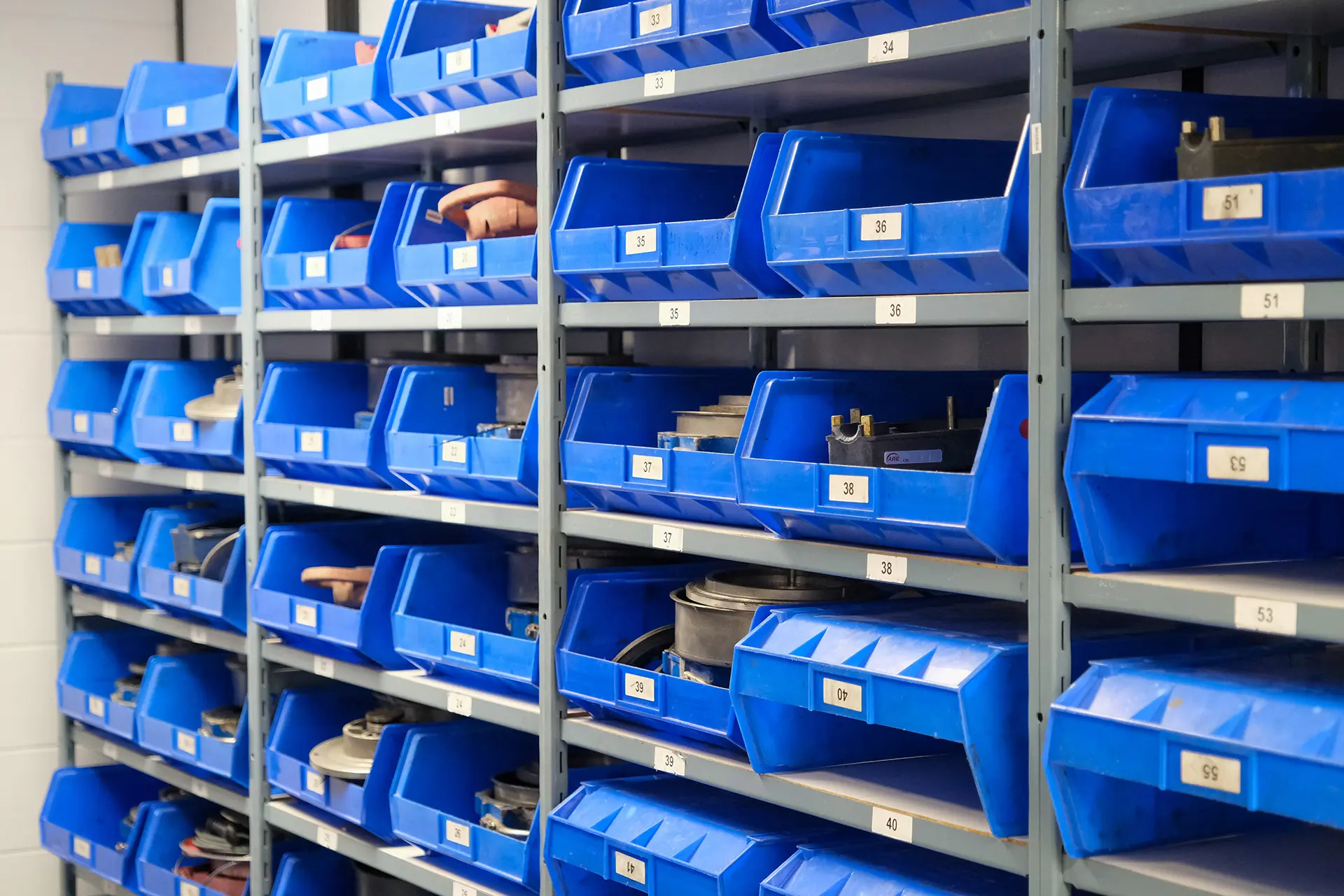 blue bins on shelves in a warehouse